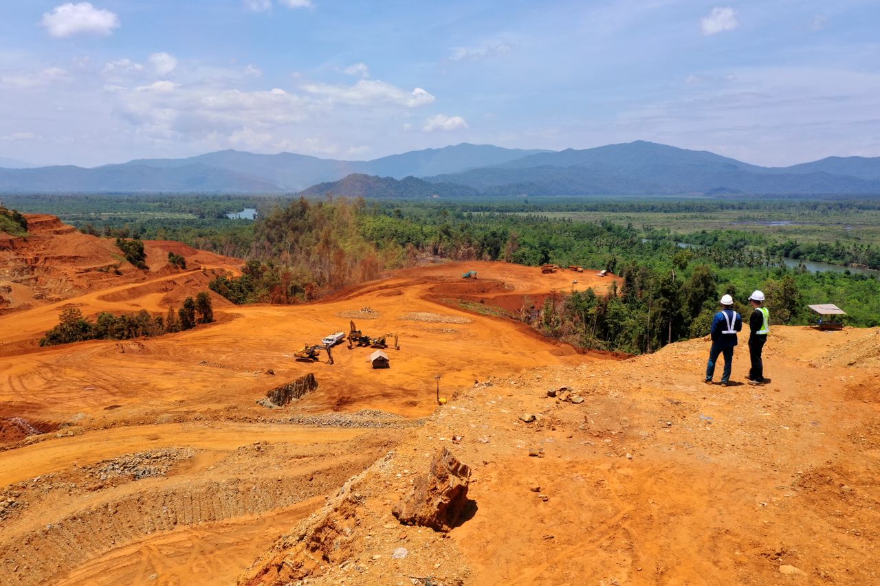 private-party-01 Expansive view of a mining area in Molawe, Sulawesi, with workers and machinery.